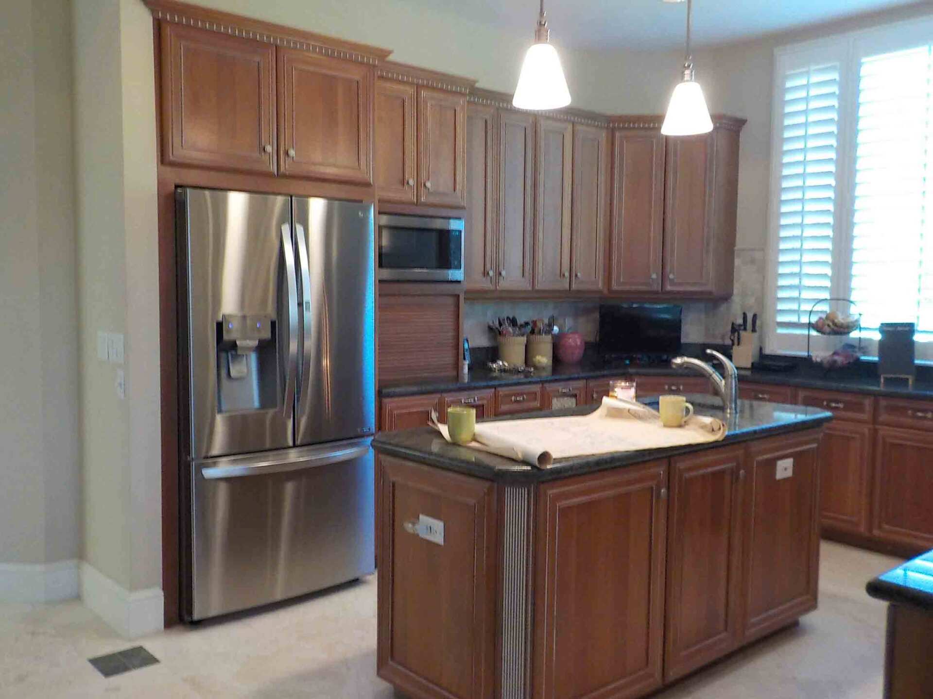 A kitchen with stainless steel appliances and wooden cabinets.