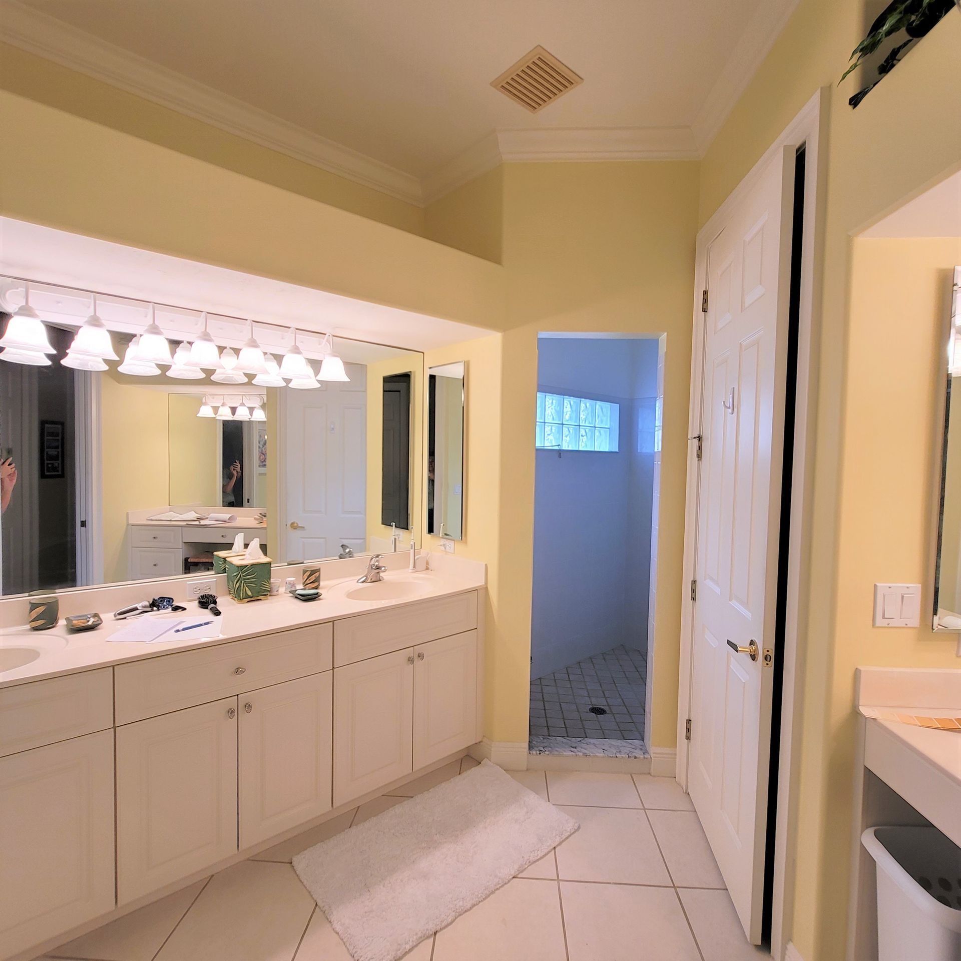A bathroom with two sinks and a large mirror.