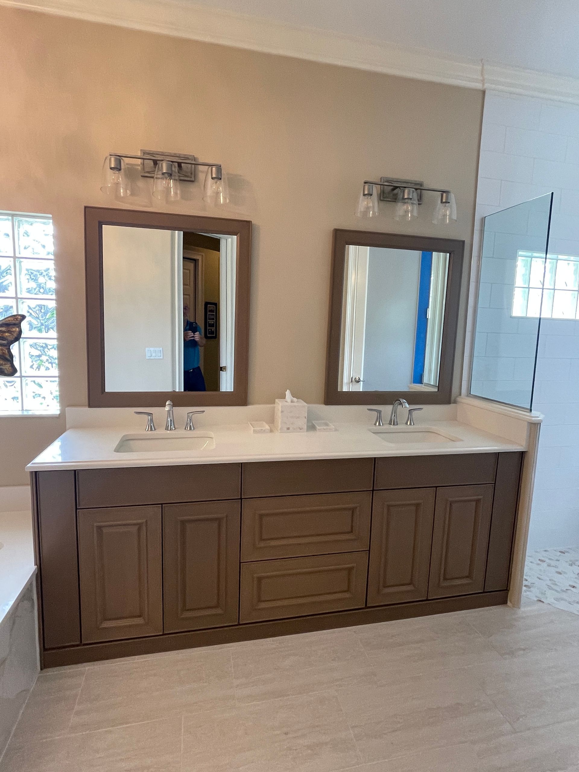 A bathroom with two sinks and two mirrors.
