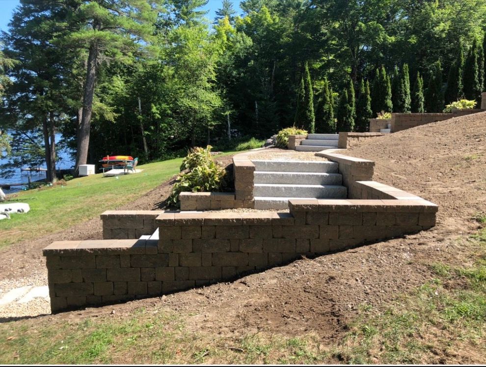 Completed natural stone patio on a Maine residential property