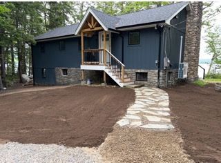 Contractor resetting displaced flagstone pavers