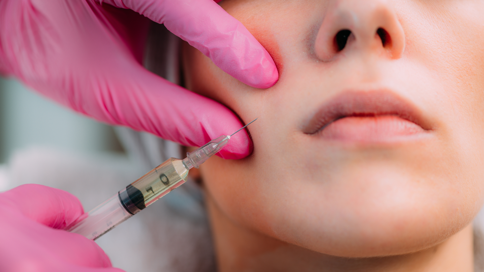 Woman getting aesthetic treatment for cheeks
