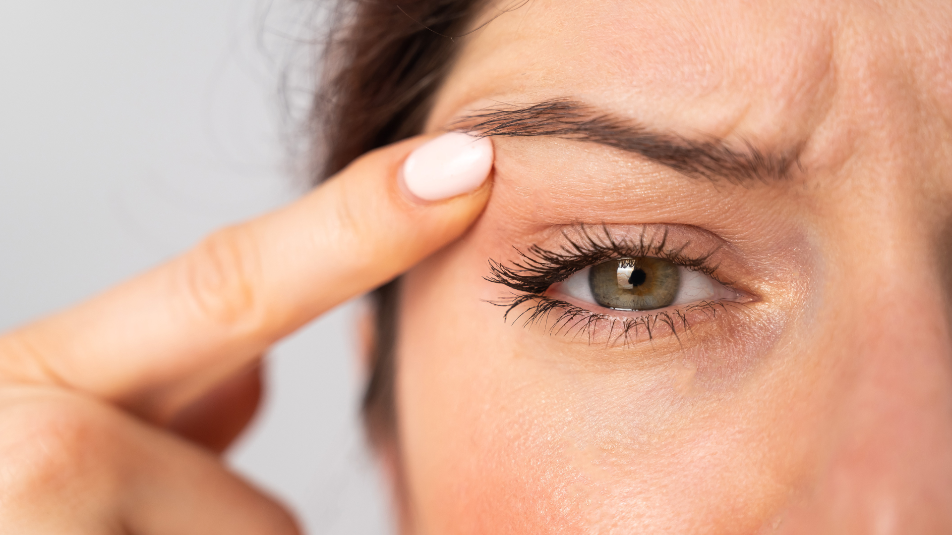 Woman pointing at eyebrows