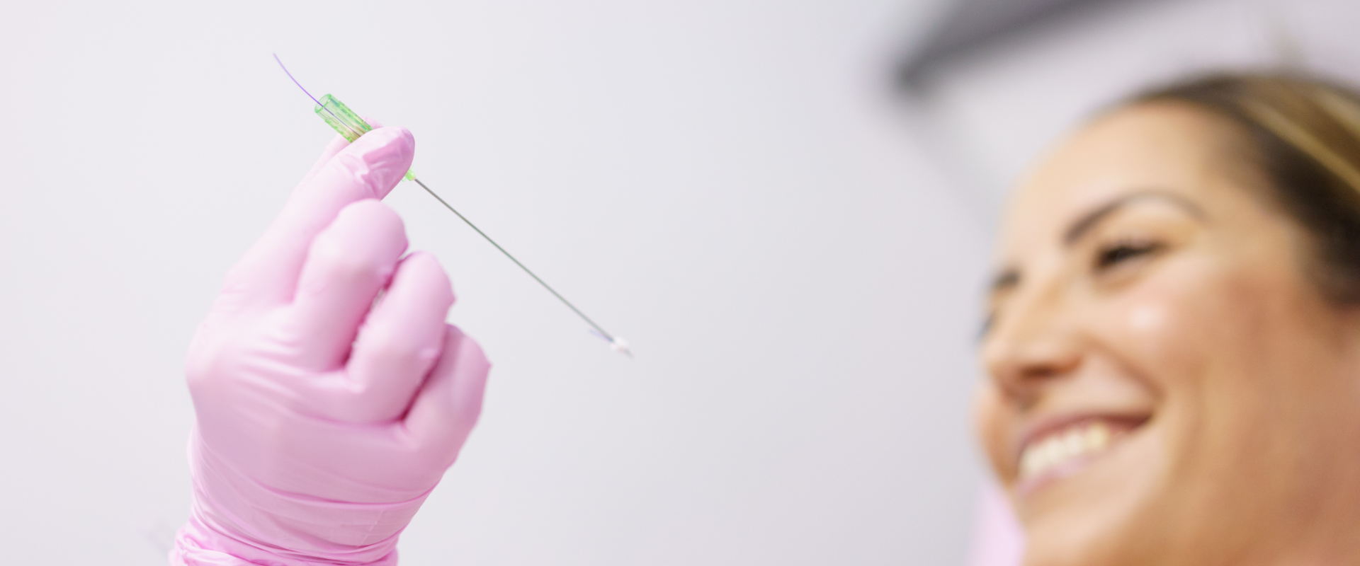 Doctor showing patient PDO thread for her jawline