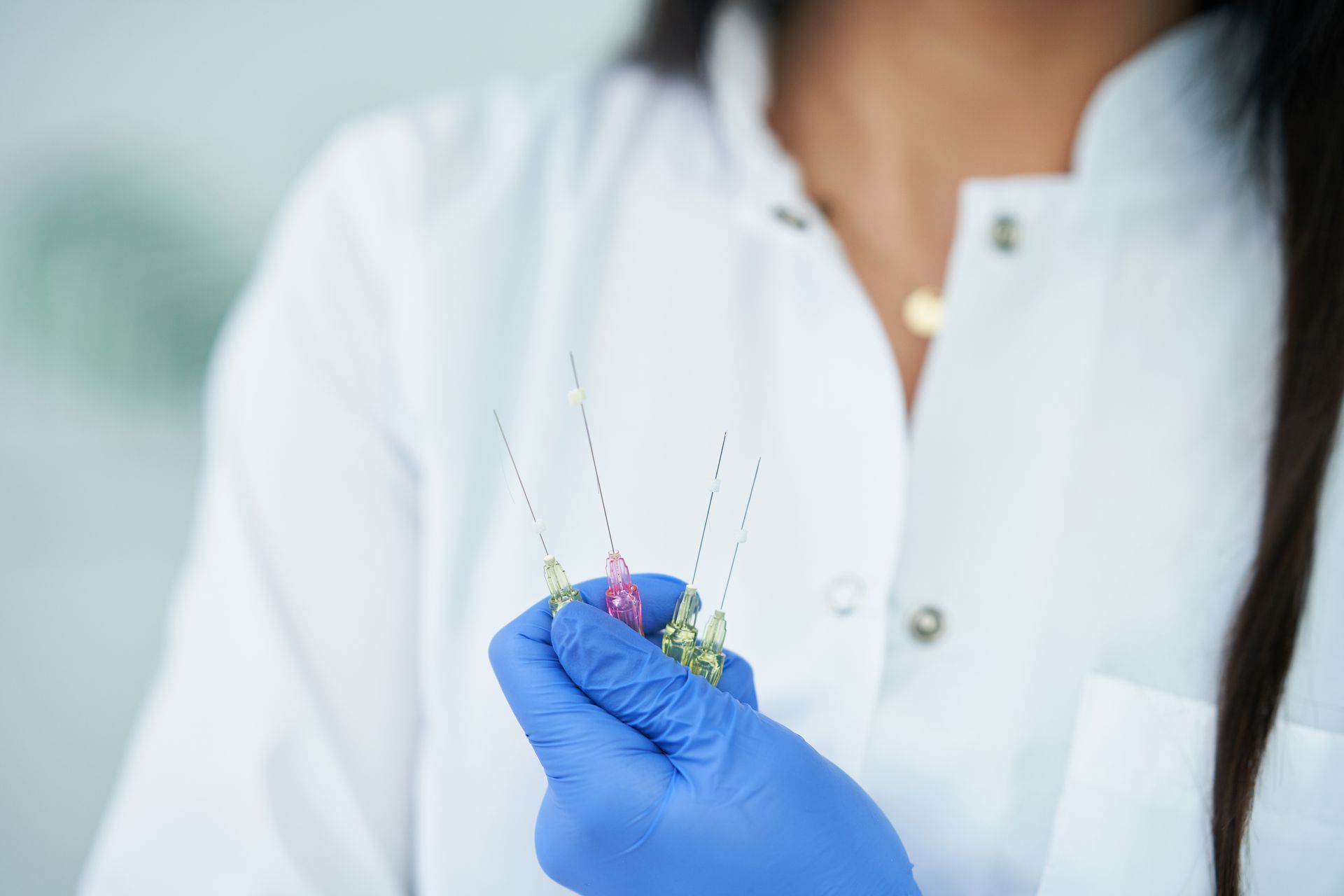 Doctor holding PDO threads preparing for a PDO thread nose job