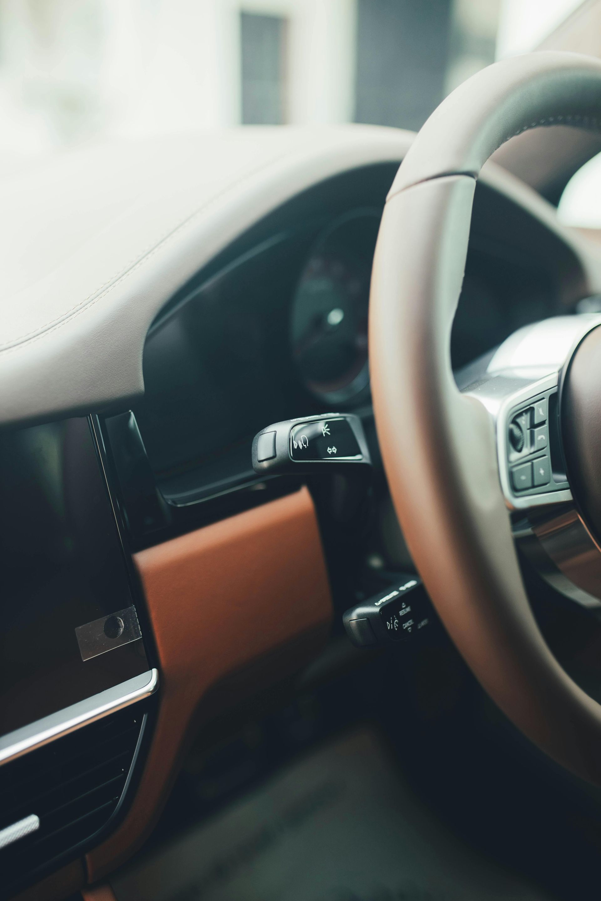 Car interior with steering wheel, dashboard, and brown accent trim close-up