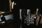 Professional podcast recording setup with microphone, headphones, audio mixer, and music notes representing music licensing, copyright compliance, and legal podcast publishing.