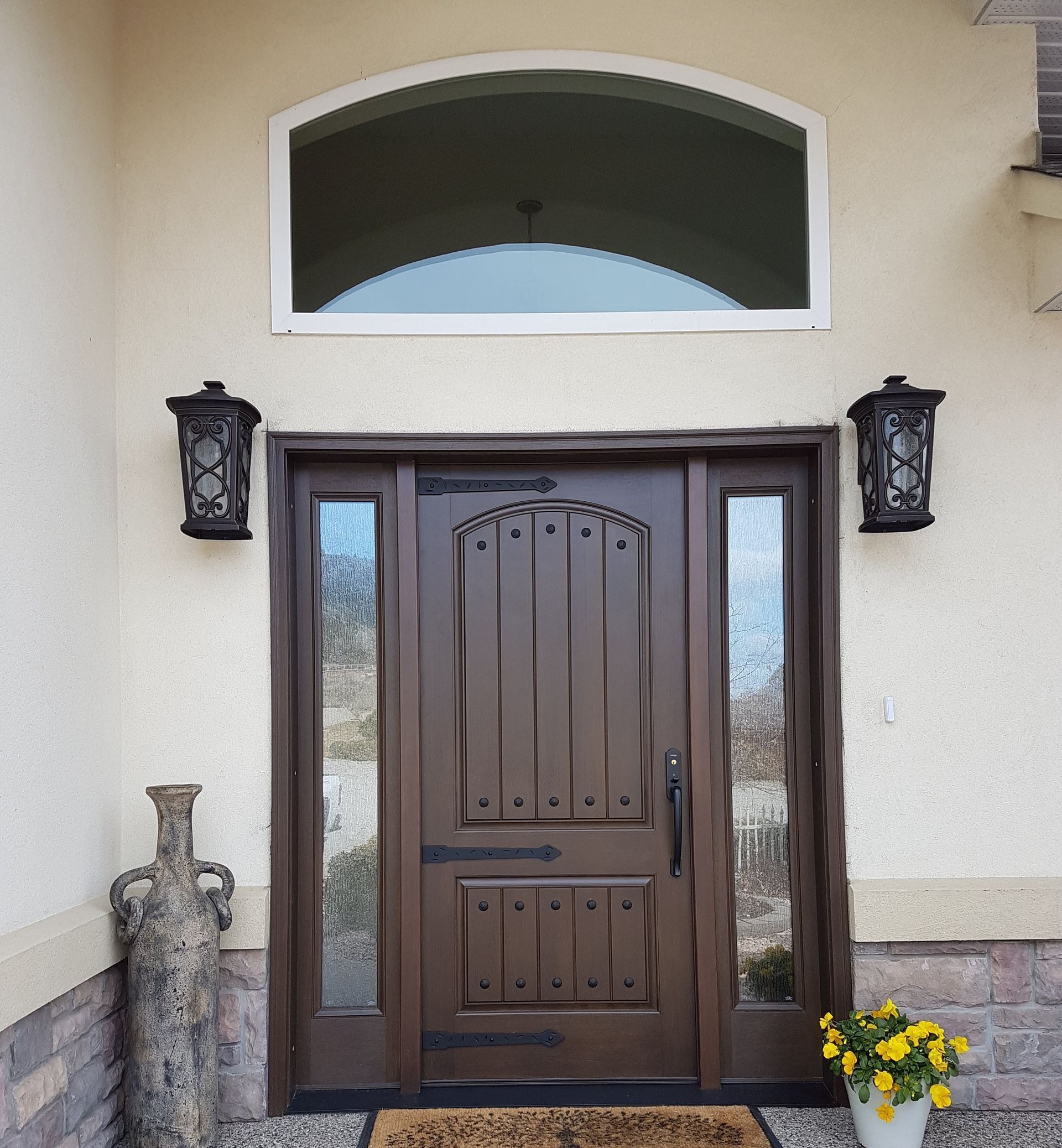 The front door of a house has a window above it