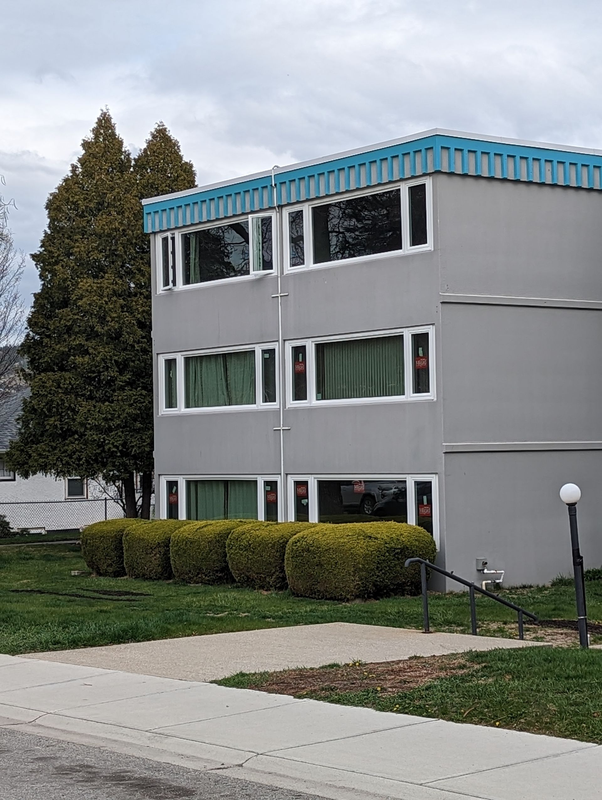 A building with a blue roof and a lot of windows
