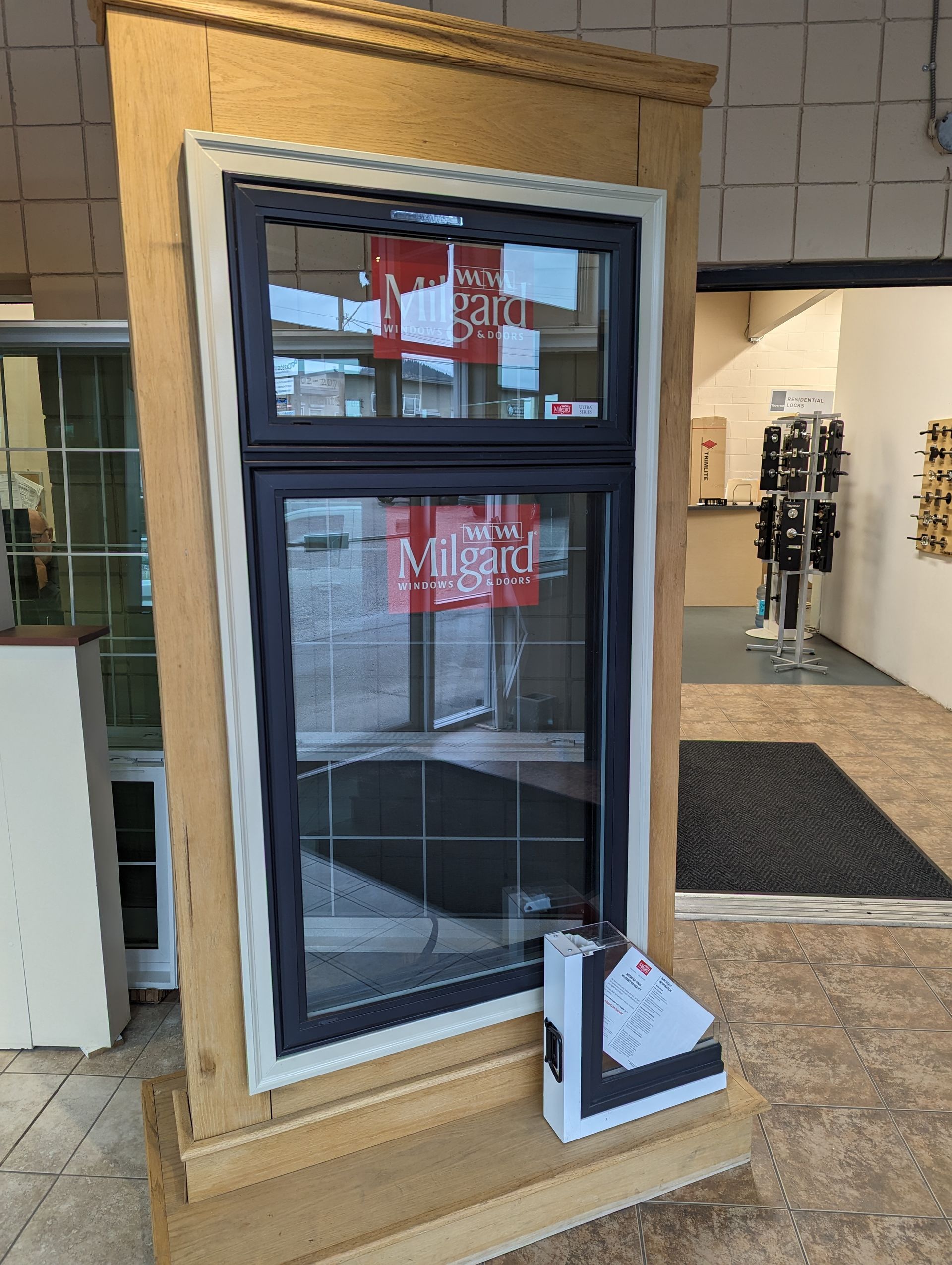 A window is sitting on top of a wooden display in a store.