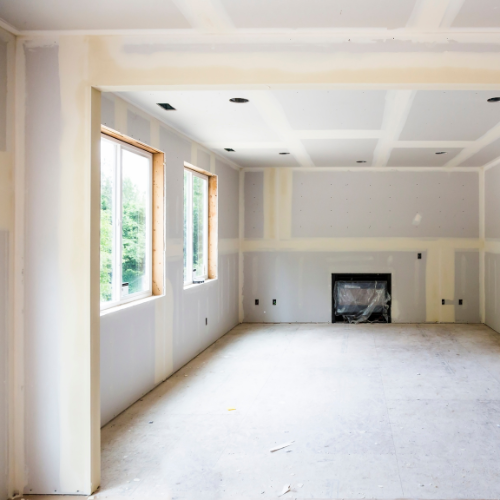 An empty room with a fireplace and a lot of windows