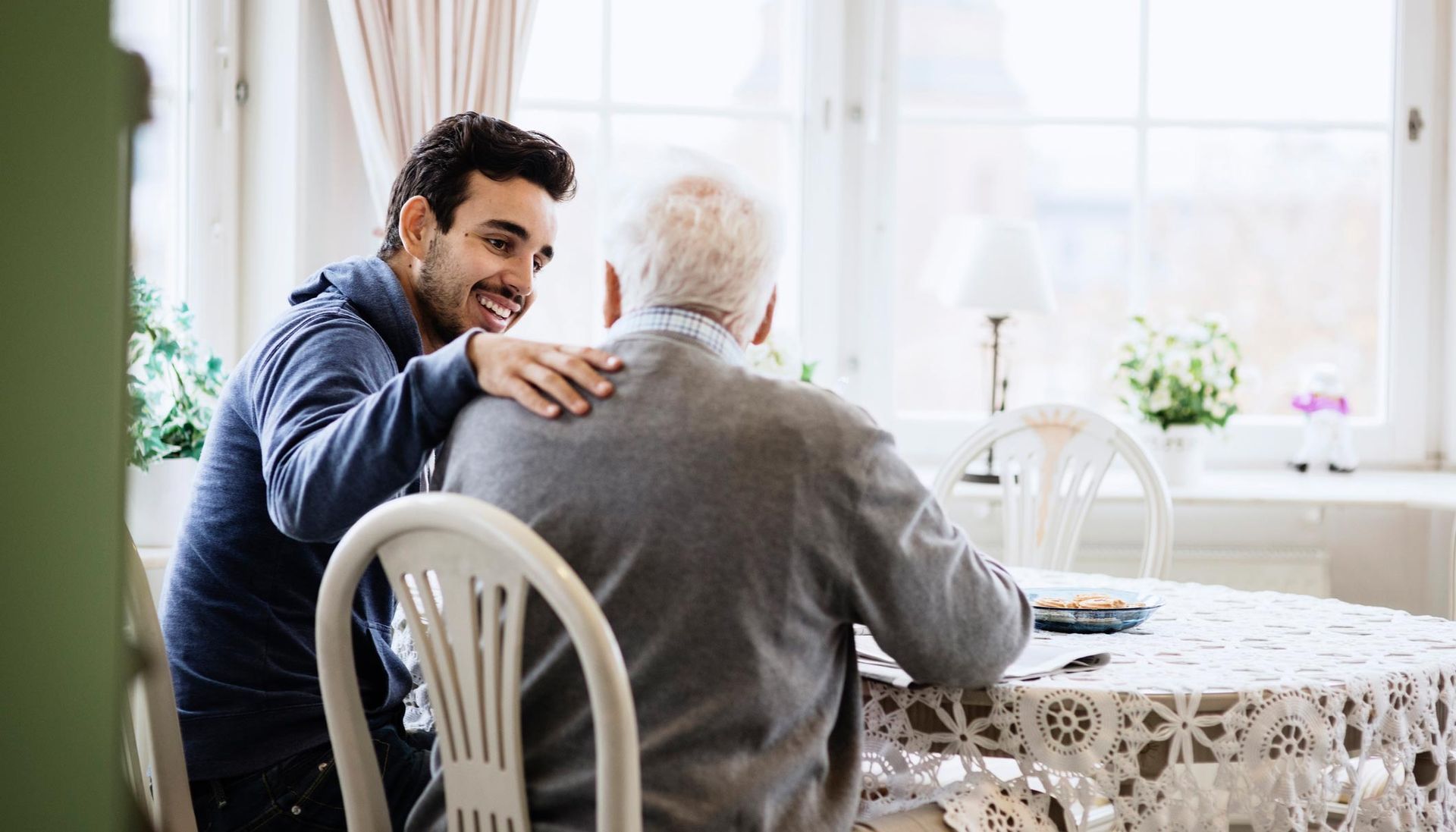Man Sitting With Older Man — Princeton, IN — Friends and Family Caregivers