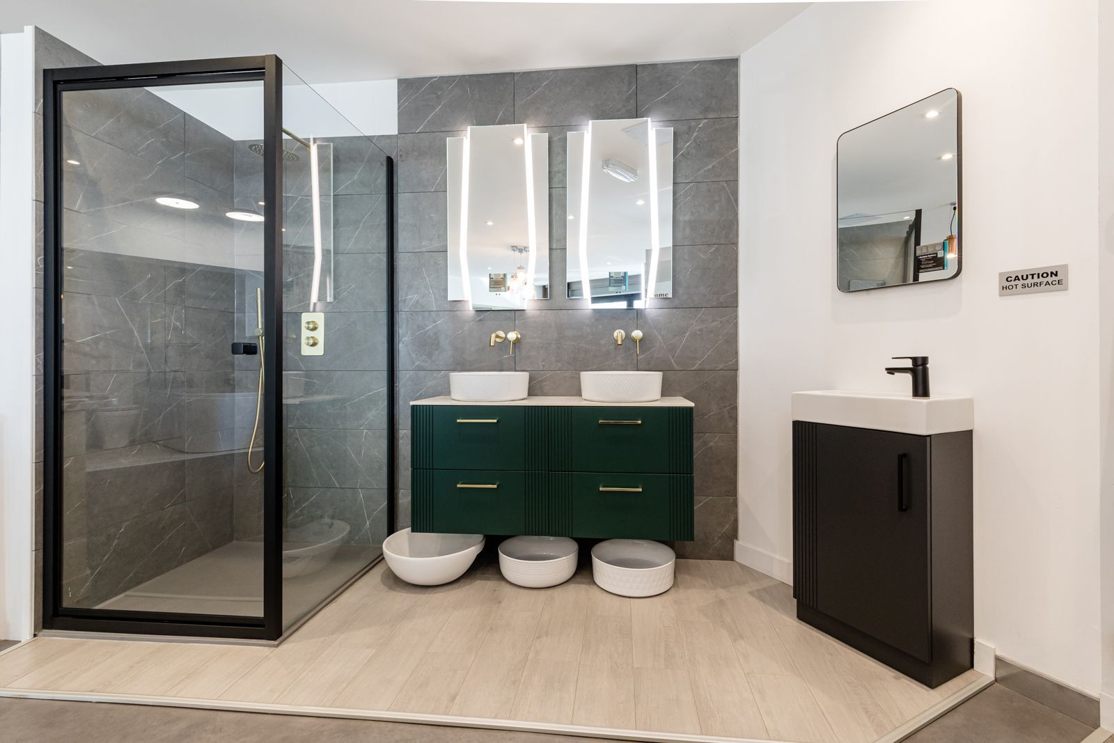A bathroom with two sinks and a walk in shower.