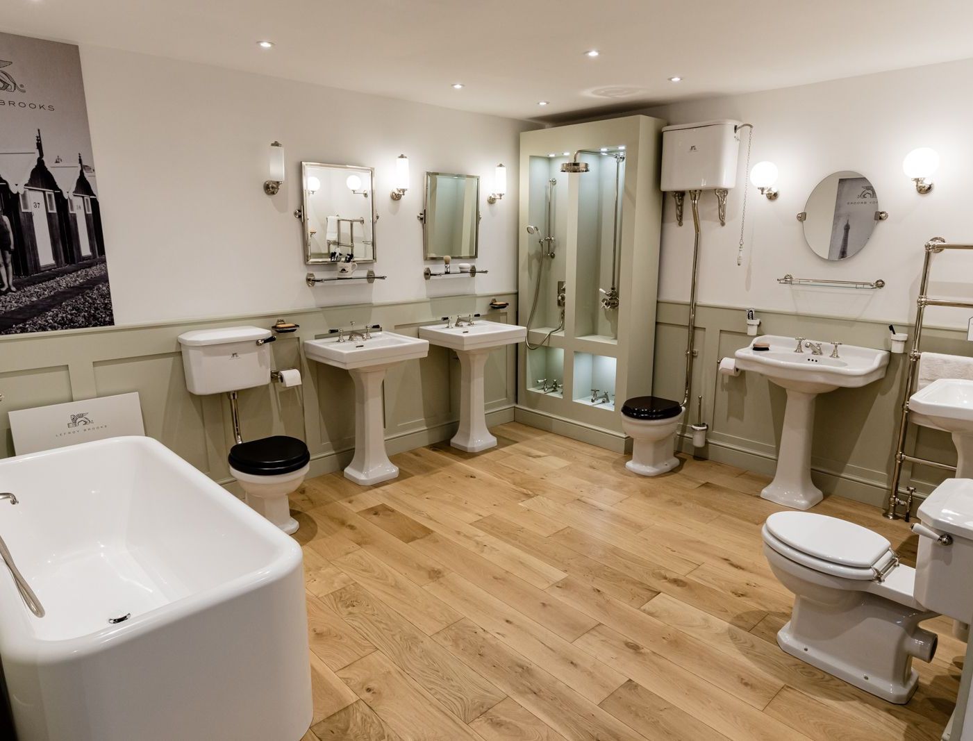 A bathroom with a bathtub , toilets , sinks and mirrors.