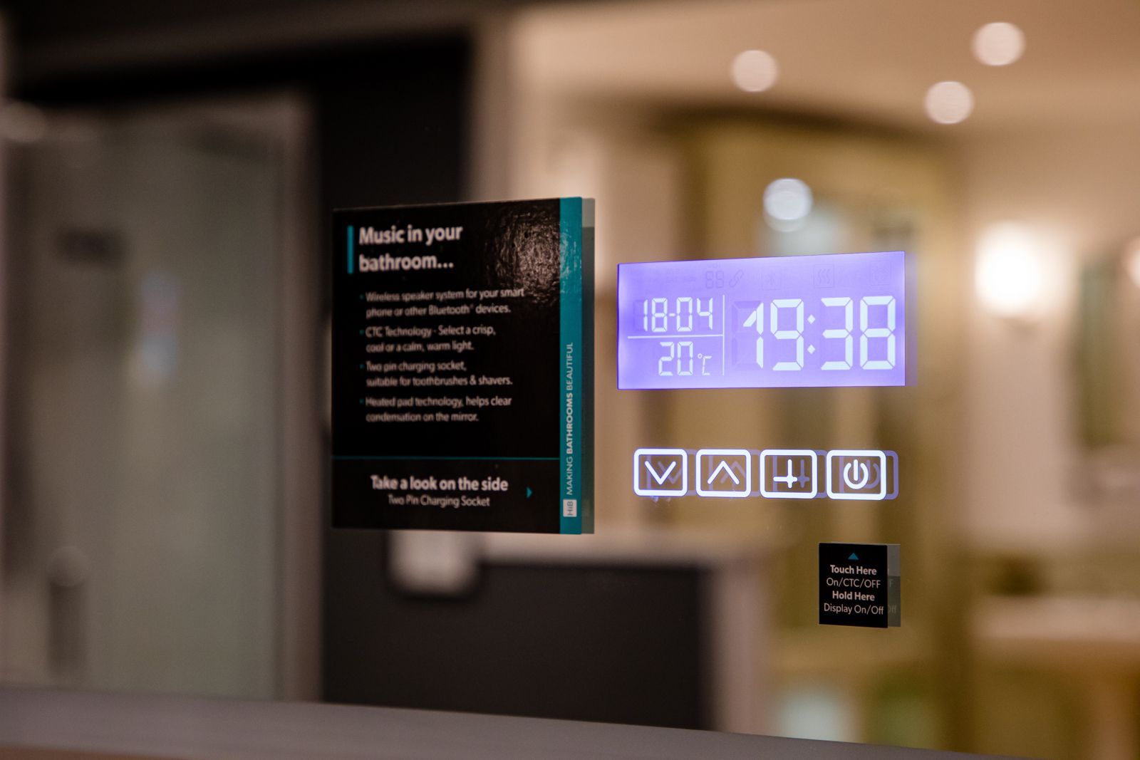 A bathroom mirror with a digital clock on it