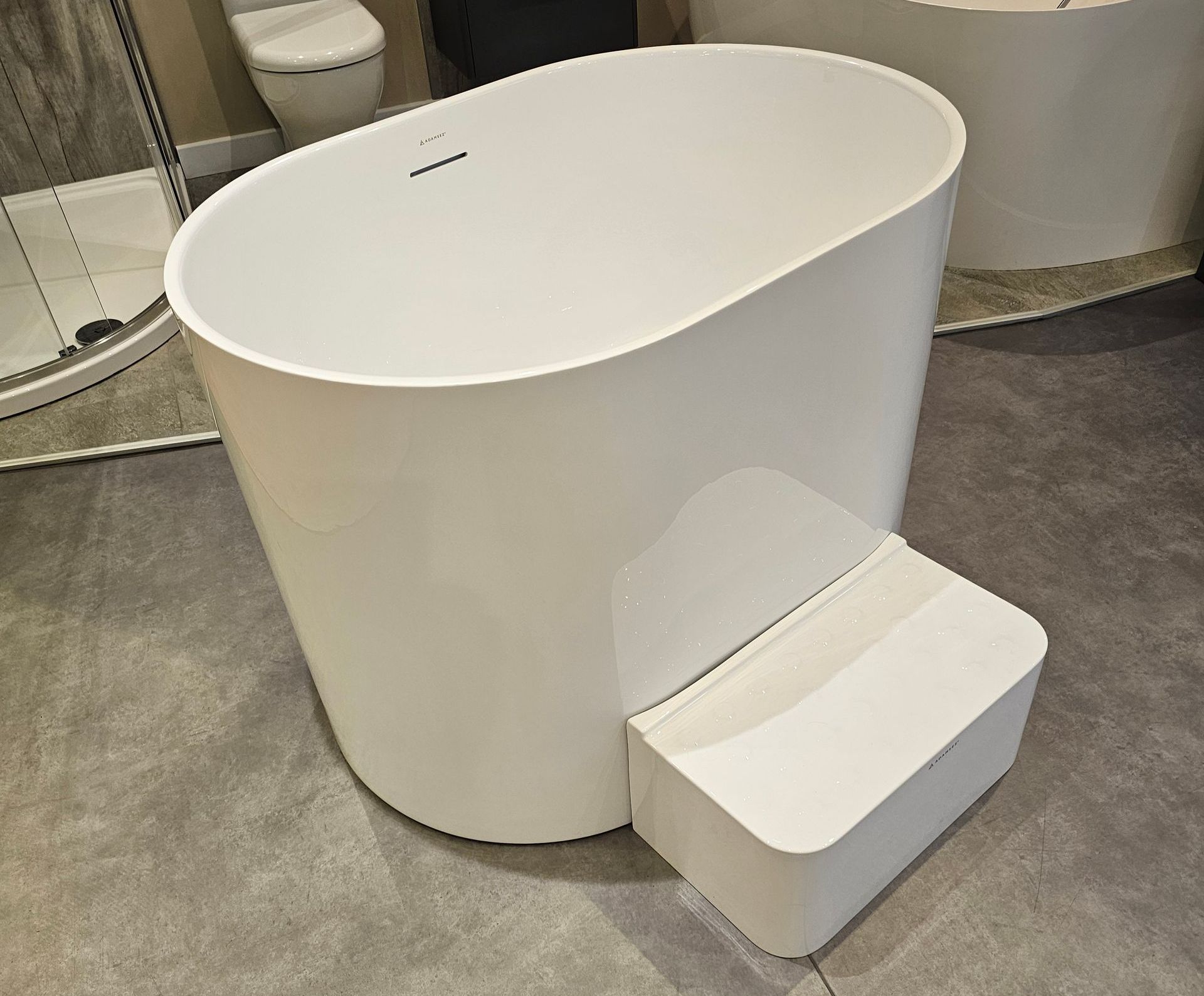 A white bathtub with steps attached to it in a bathroom.