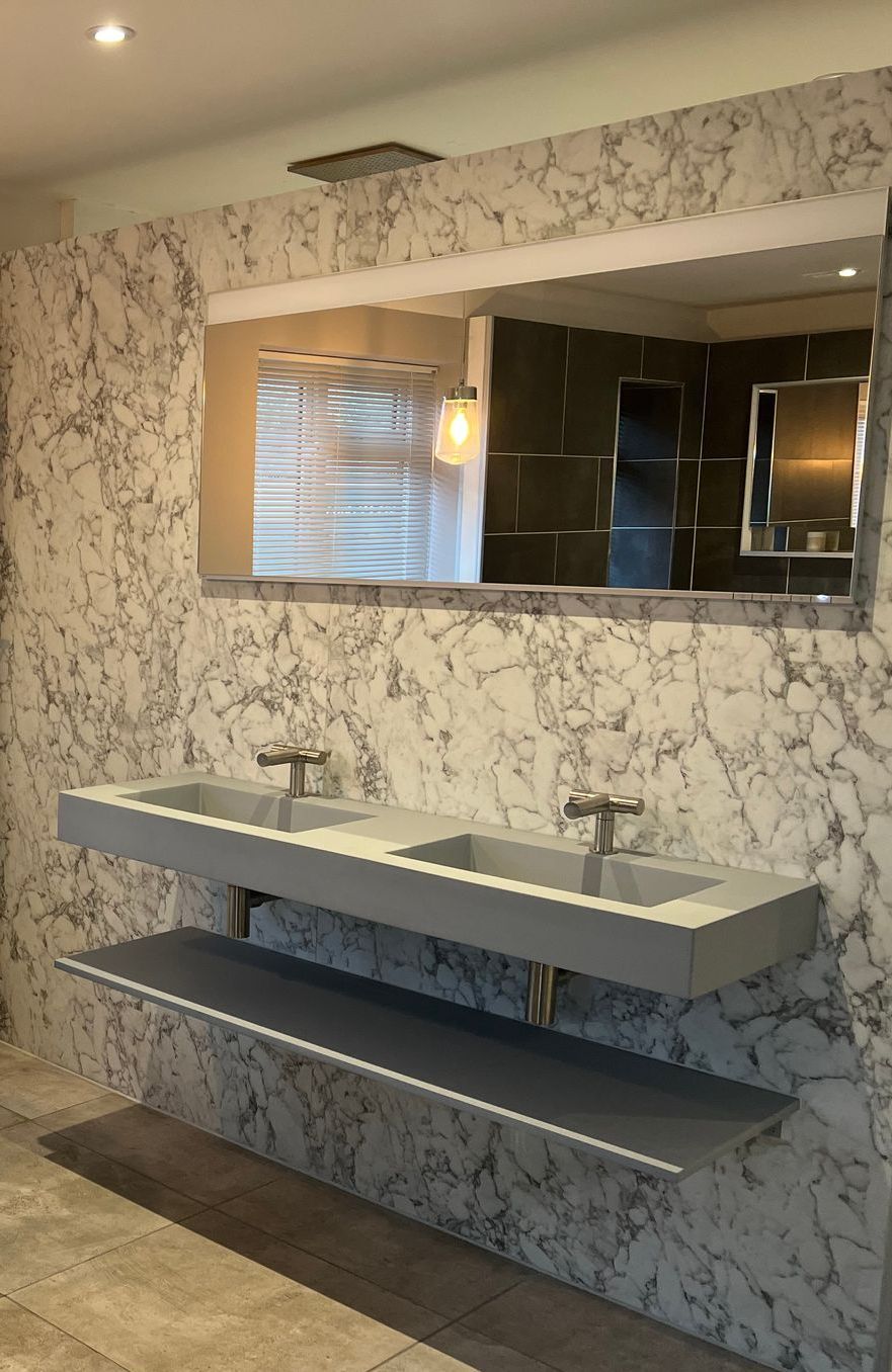 a bathroom with two sinks and a large mirror