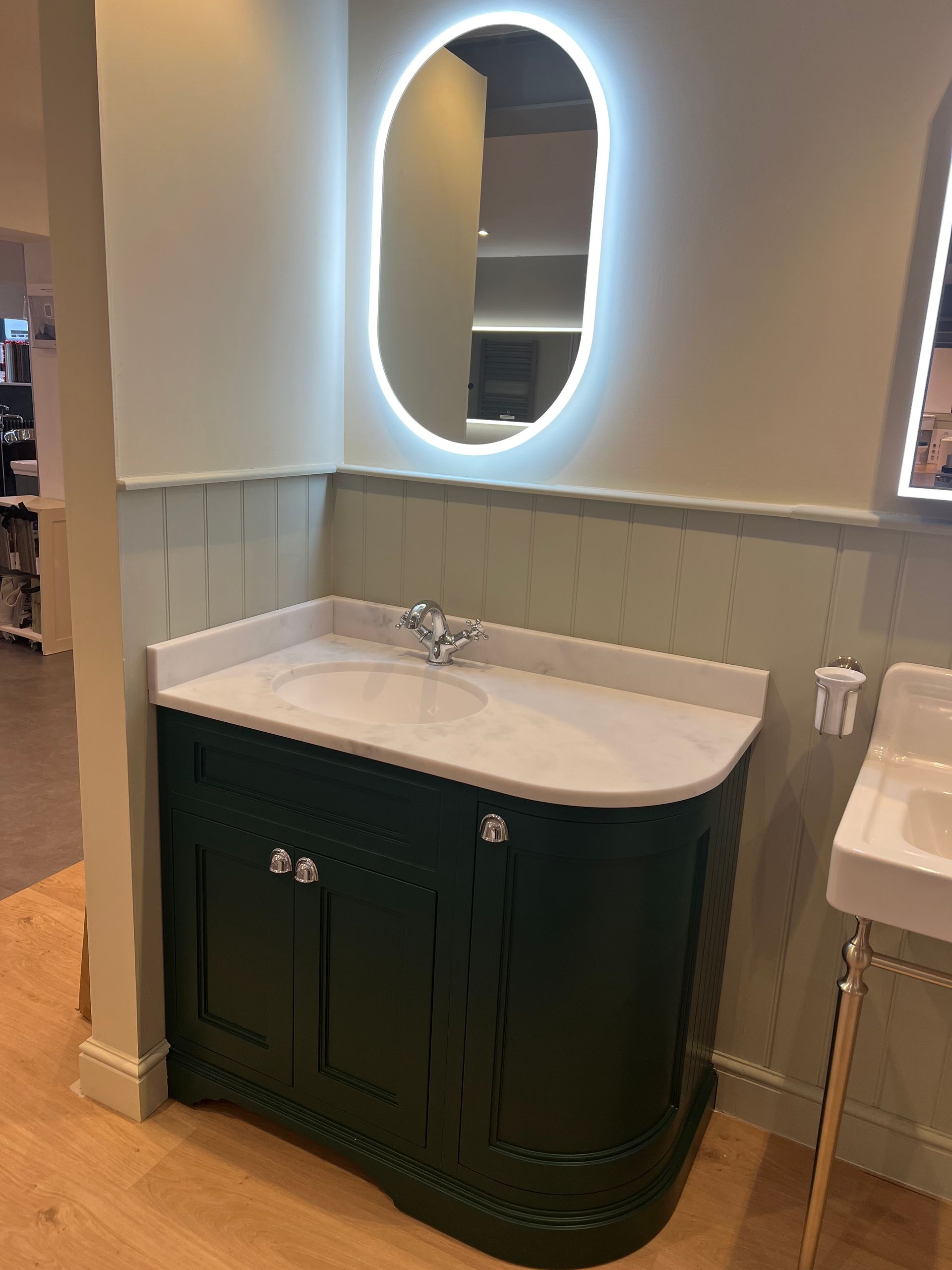A bathroom with a sink and a mirror on the wall.