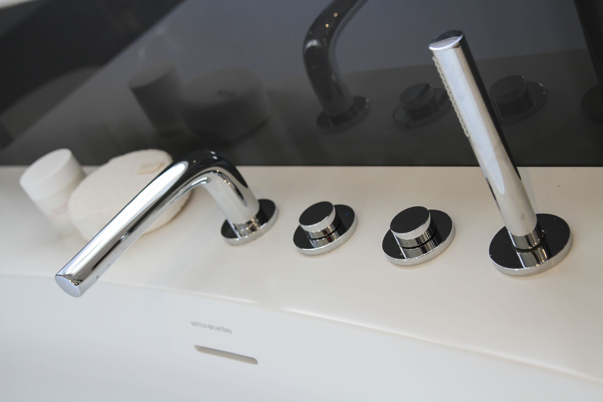 A close up of a bathtub with chrome faucets