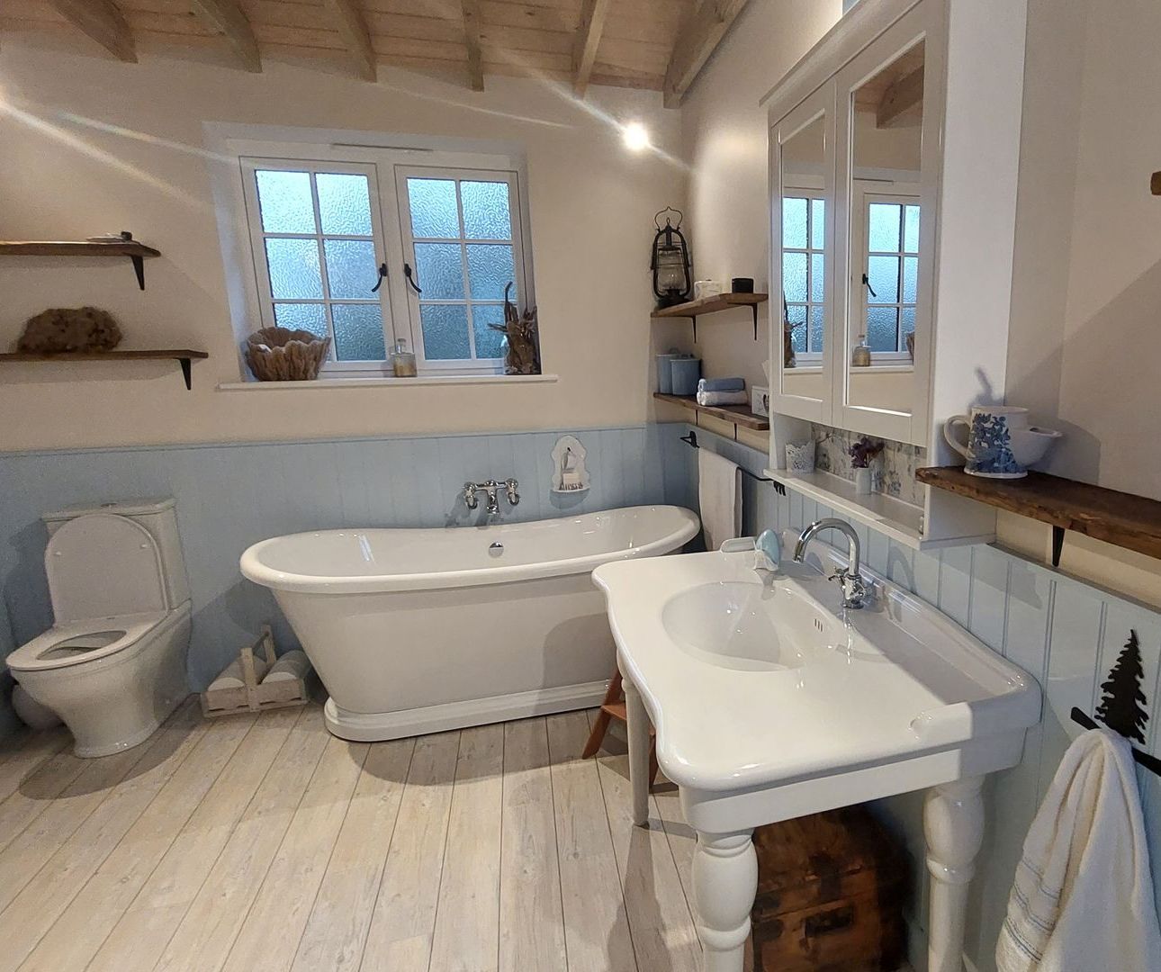 A bathroom with a tub a sink and a toilet