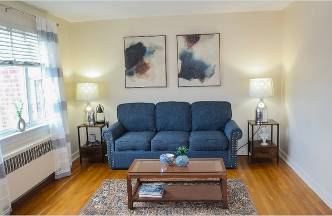 A living room with a blue couch and a coffee table