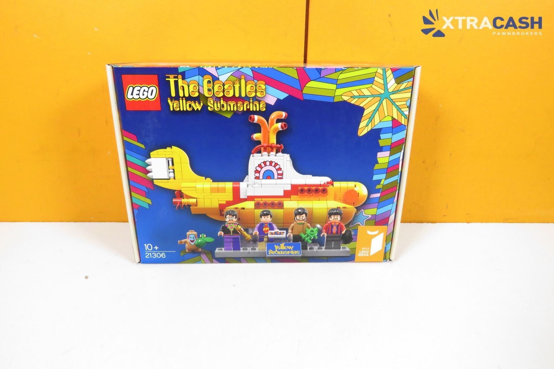 LEGO The Beatles Yellow Submarine set box on a white surface against an orange wall