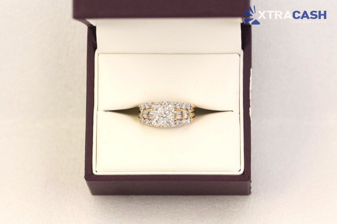 Diamond ring in a black jewelry box with white lining and a gold band, shown on a light background