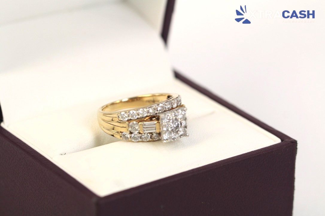 Diamond ring in a black jewelry box with white lining and a gold band, shown on a light background