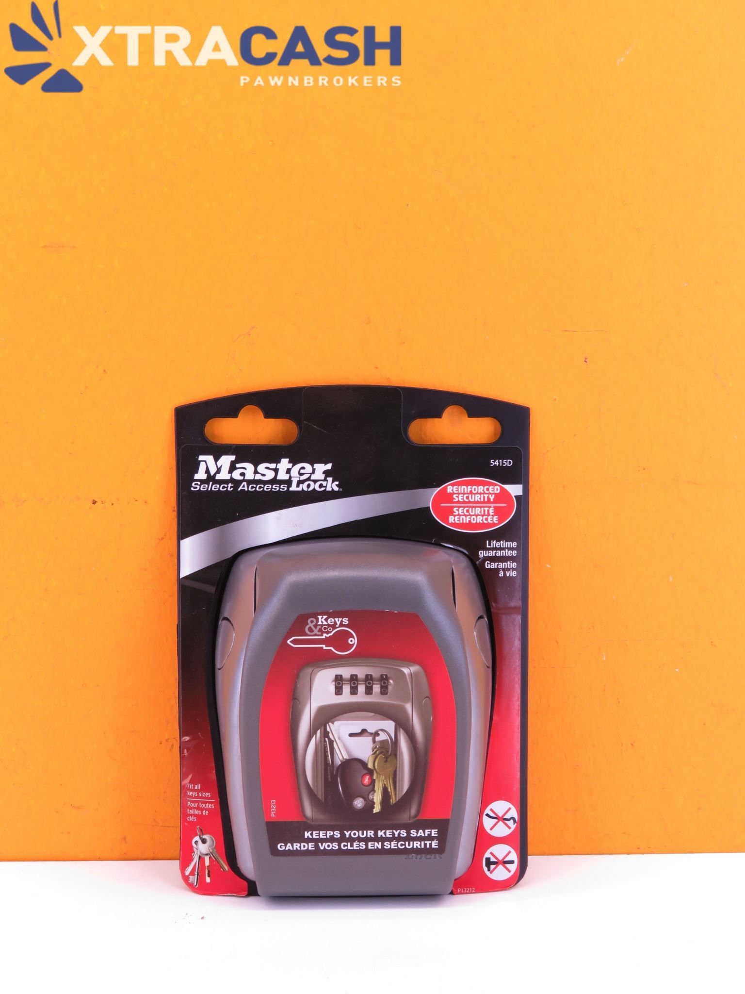 Master Lock combination padlock in red and black packaging on an orange background