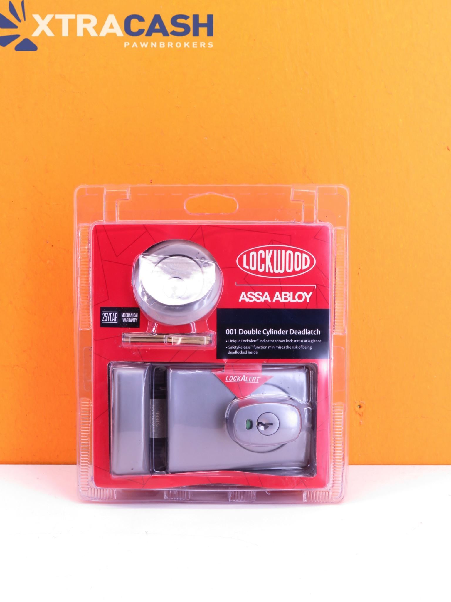 Two-pack of silver and red lock accessories in clear packaging on an orange background