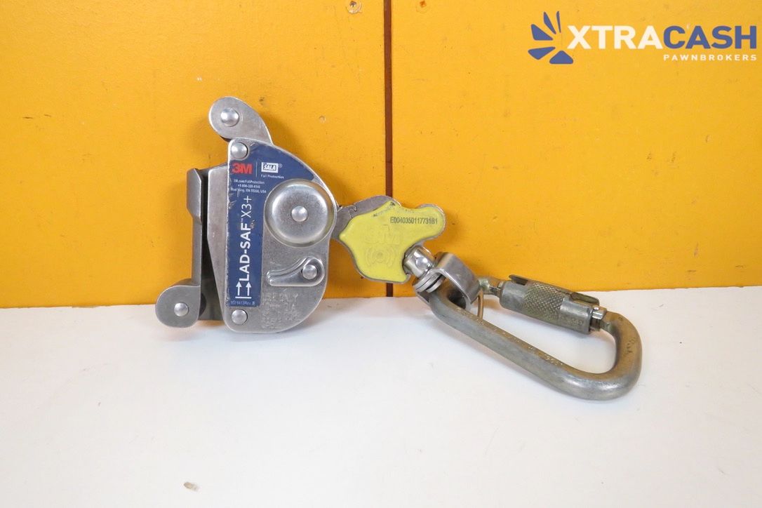 Blue-and-silver XTRACASH device with a carabiner on a yellow and white background