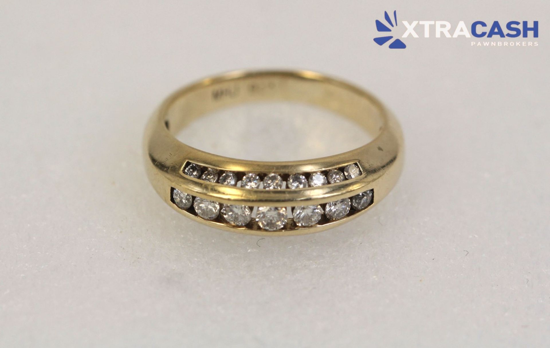 Gold ring with two rows of clear stones on a white background