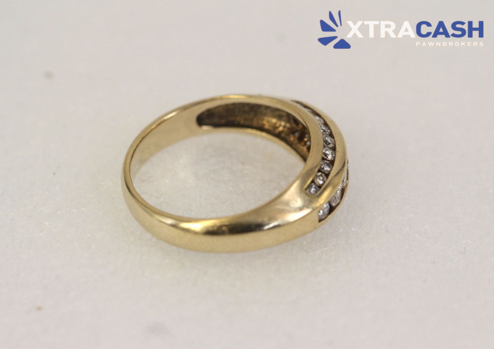 Gold ring with two rows of clear stones on a white background