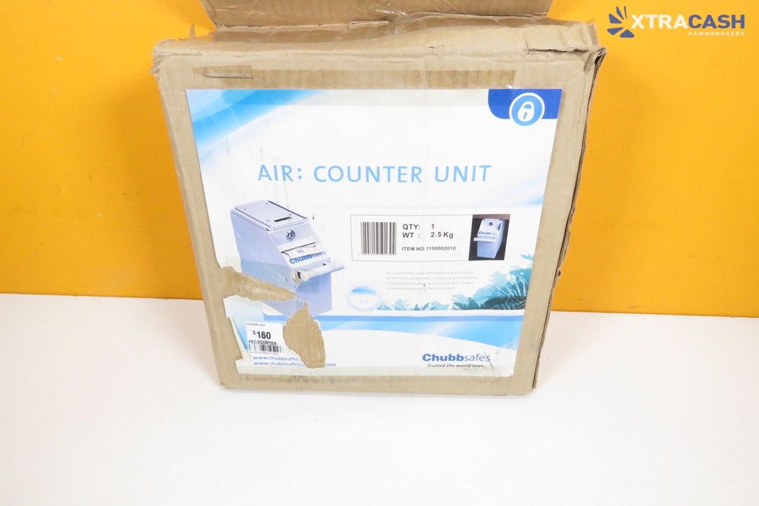 Brown cardboard box labeled “MR. COUNTER UNIT” on a yellow surface, with XTRACASH logo in the corner