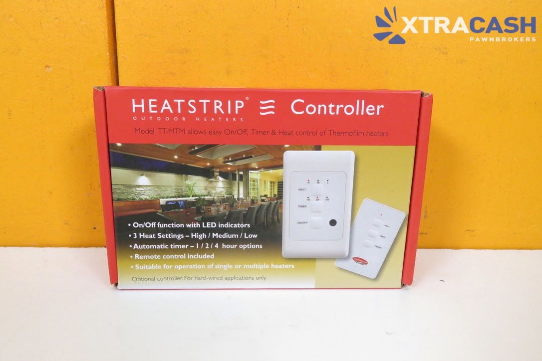 Heatstrip controller product box on a white surface against an orange wall.