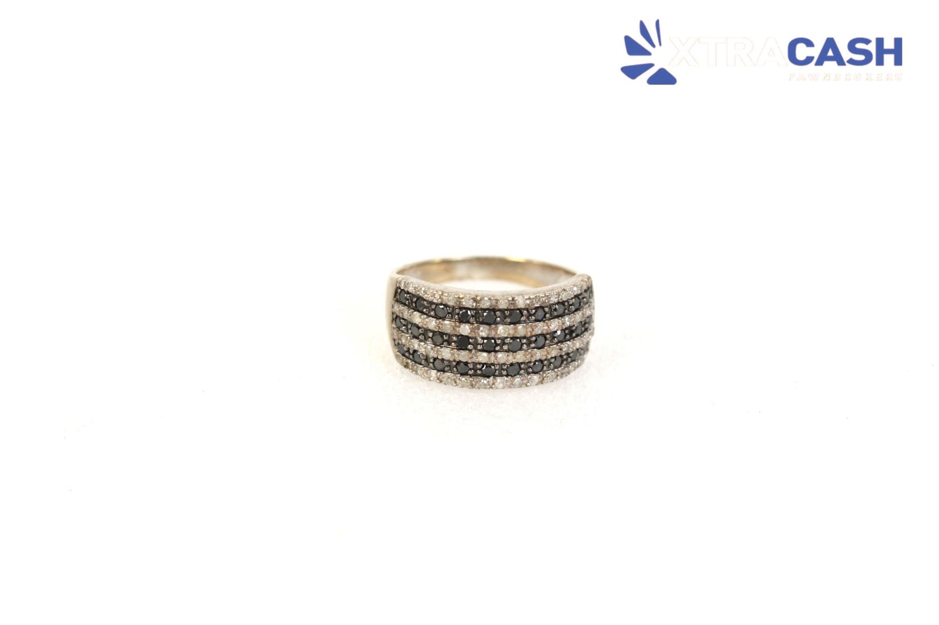 Stacked silver ring with black stones on a white background