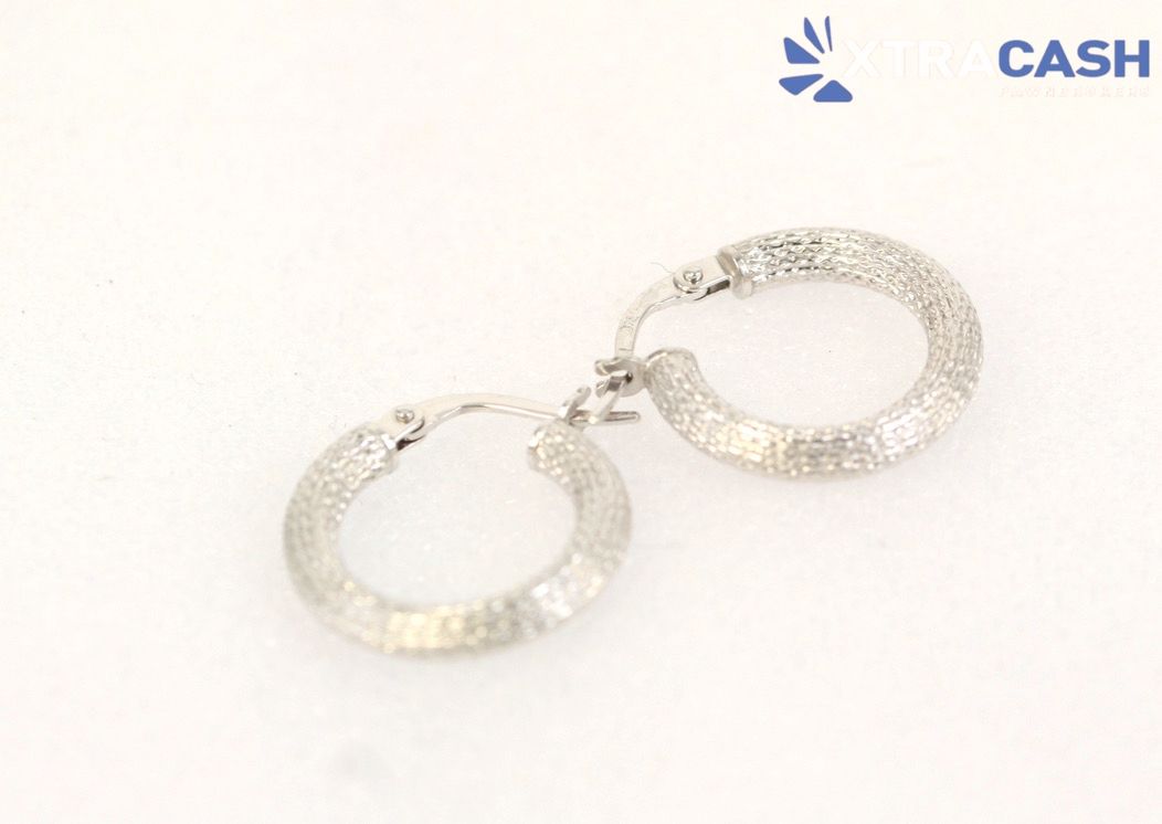 Two silver hoop earrings on a white background