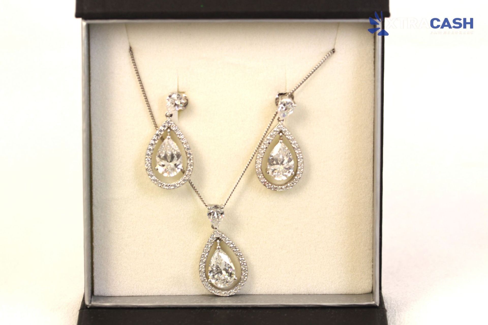 Silver teardrop necklace and earrings set displayed in a black jewelry box