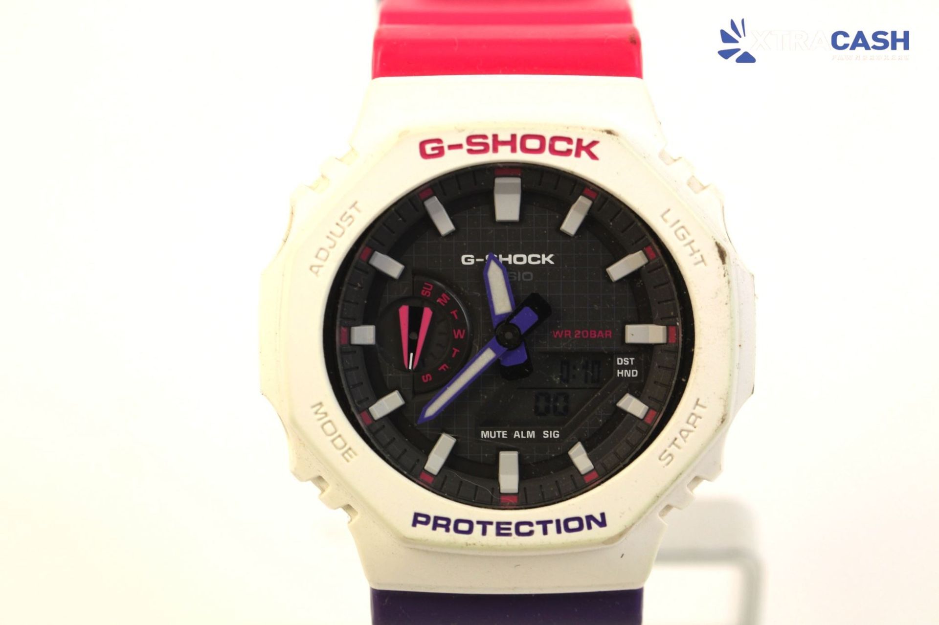 G-SHOCK wristwatch with cream bezel, black face, and pink strap on a white background