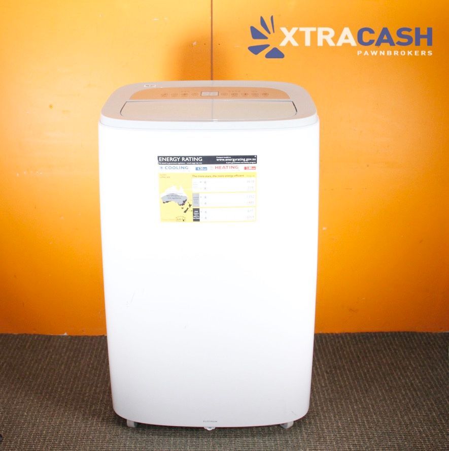 White top-load washing machine against an orange wall with XTRACASH logo above it