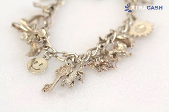 Silver chain bracelet in a red jewelry box on a white background.