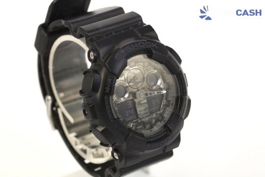 Black digital wristwatch with a clear case and bulky strap on a white background