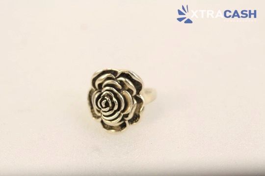 Silver floral ring with a black-stone rose design on a light background