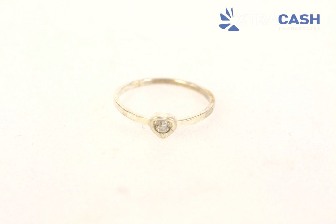 Gold ring with a round clear stone on a white background, labeled “CASH” in the corner