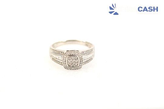 Diamond-encrusted gold ring with a square center stone on a white background