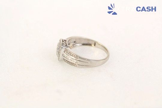 Diamond-encrusted gold ring with a square center stone on a white background
