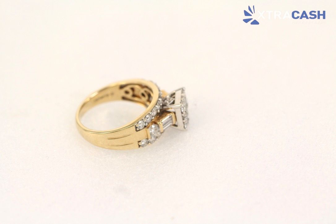 Open burgundy ring box with diamond ring and gold bands inside, Michael Hill logo visible