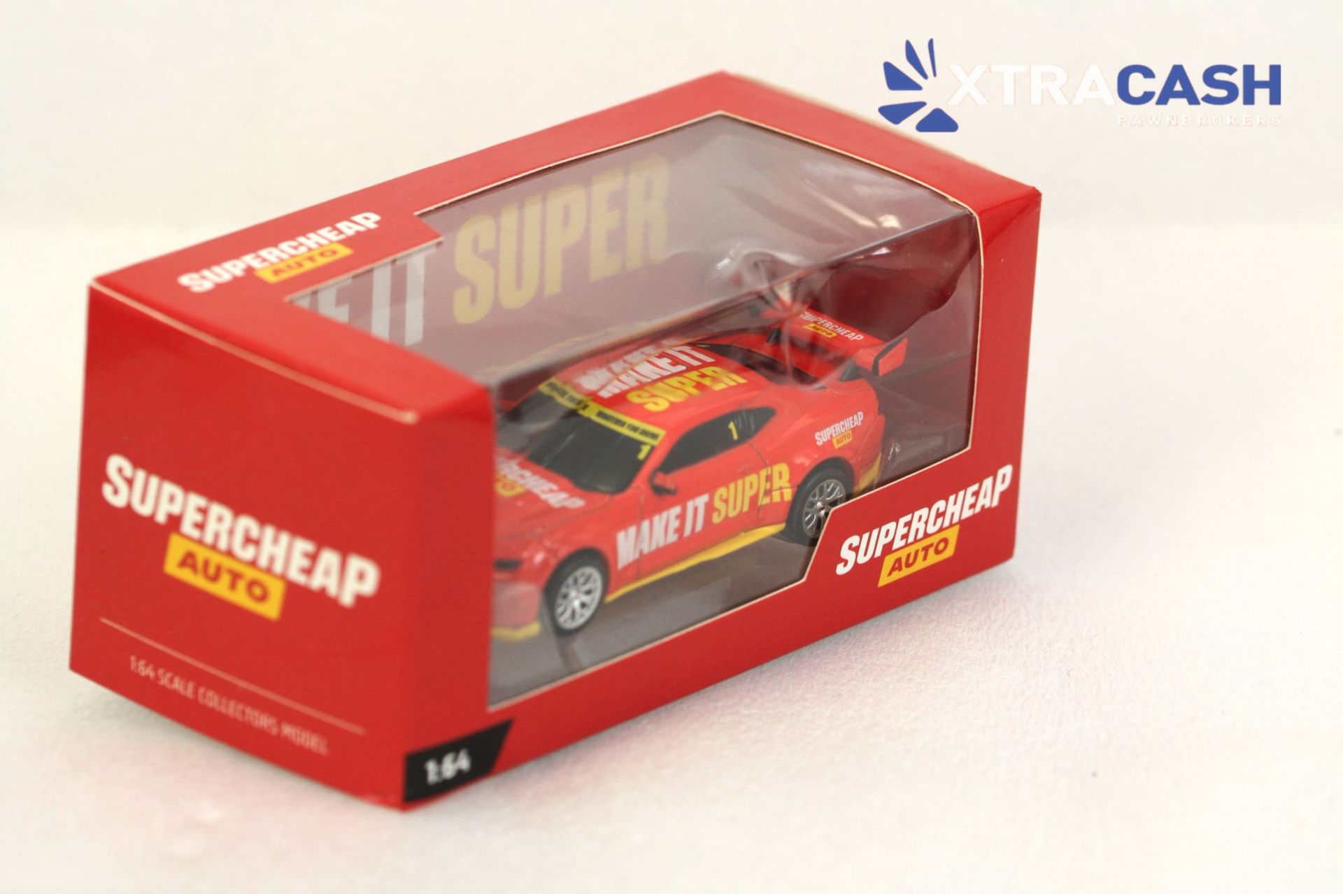 Red Supercheap Auto toy race car in a red display box with “MAKE IT SUPER” text.