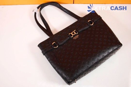 Brown patterned handbag with black straps and gold hardware on a white background