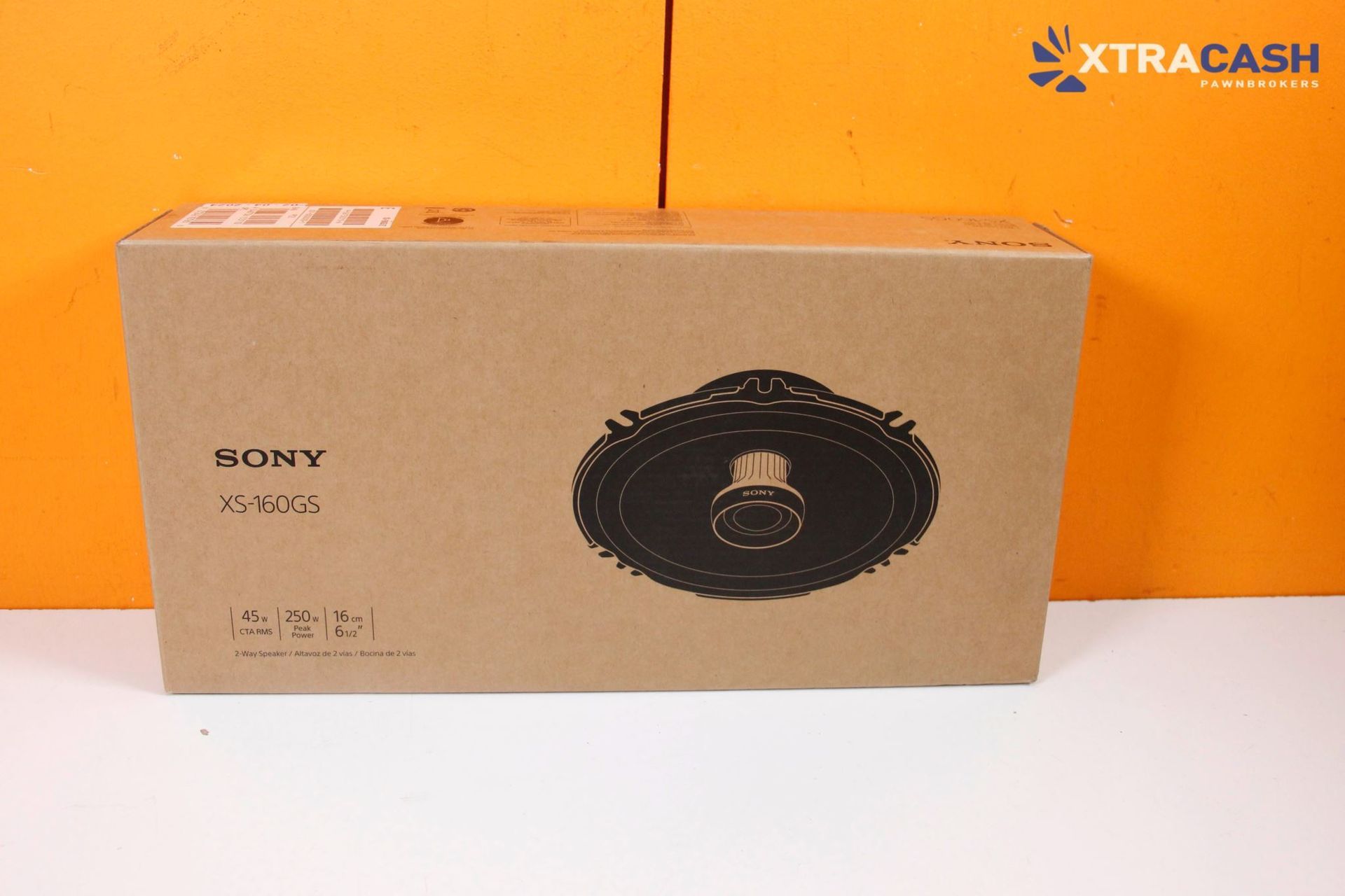 Two black round car speakers, one front view and one rear view with exposed wiring.